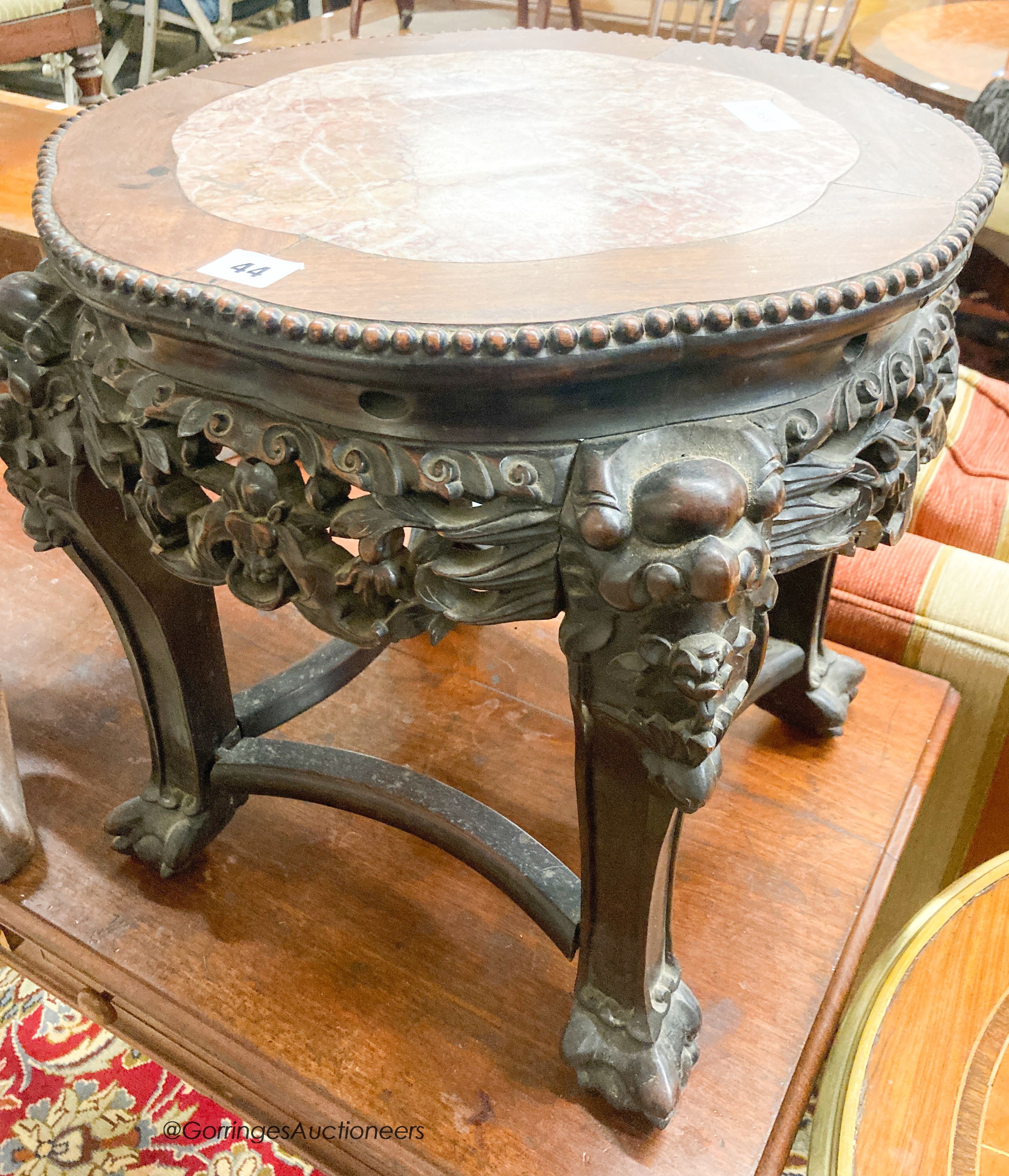 A Chinese carved hardwood jardiniere stand with rouge marble inset top, width 44cm, height 45cm